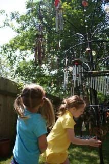 kids play with wind chimes
